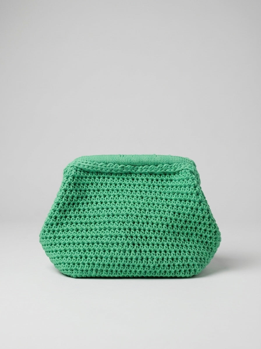 Hand-stitched green yarn into an elegant clutch.