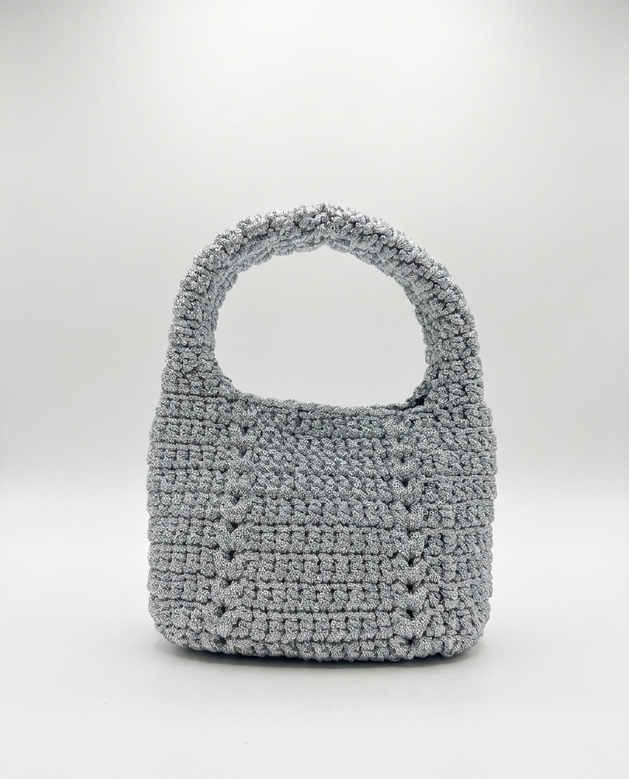 Gray crochet handbag on a white background